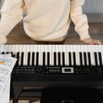 person standing in front of a piano